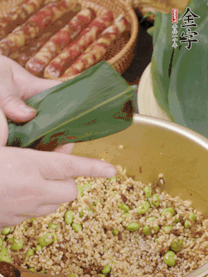 粽葉往下折，完全蓋住，兩側捏緊。